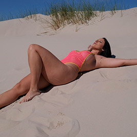 Curvy bikini model in a naughty mesh bikini