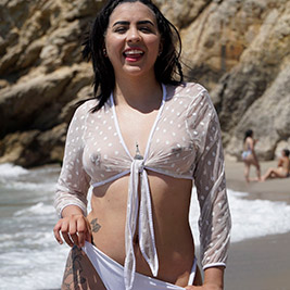 Latina bikini model spreads on the beach