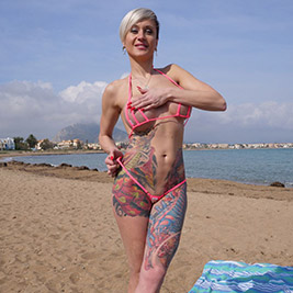 Tall bikini model wears crotchless bottoms on a public beach!
